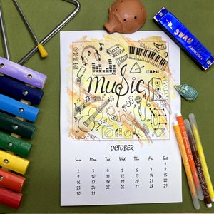 May include: A colorful October calendar with musical instrument illustrations, including a guitar, microphone, and piano. A blue harmonica, a wooden xylophone, and a triangle are also visible. The word "Music" is written in cursive.