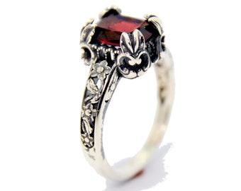 Wonderful handmade 14K White Gold ring , With oblong Garnet with a gentle filigree