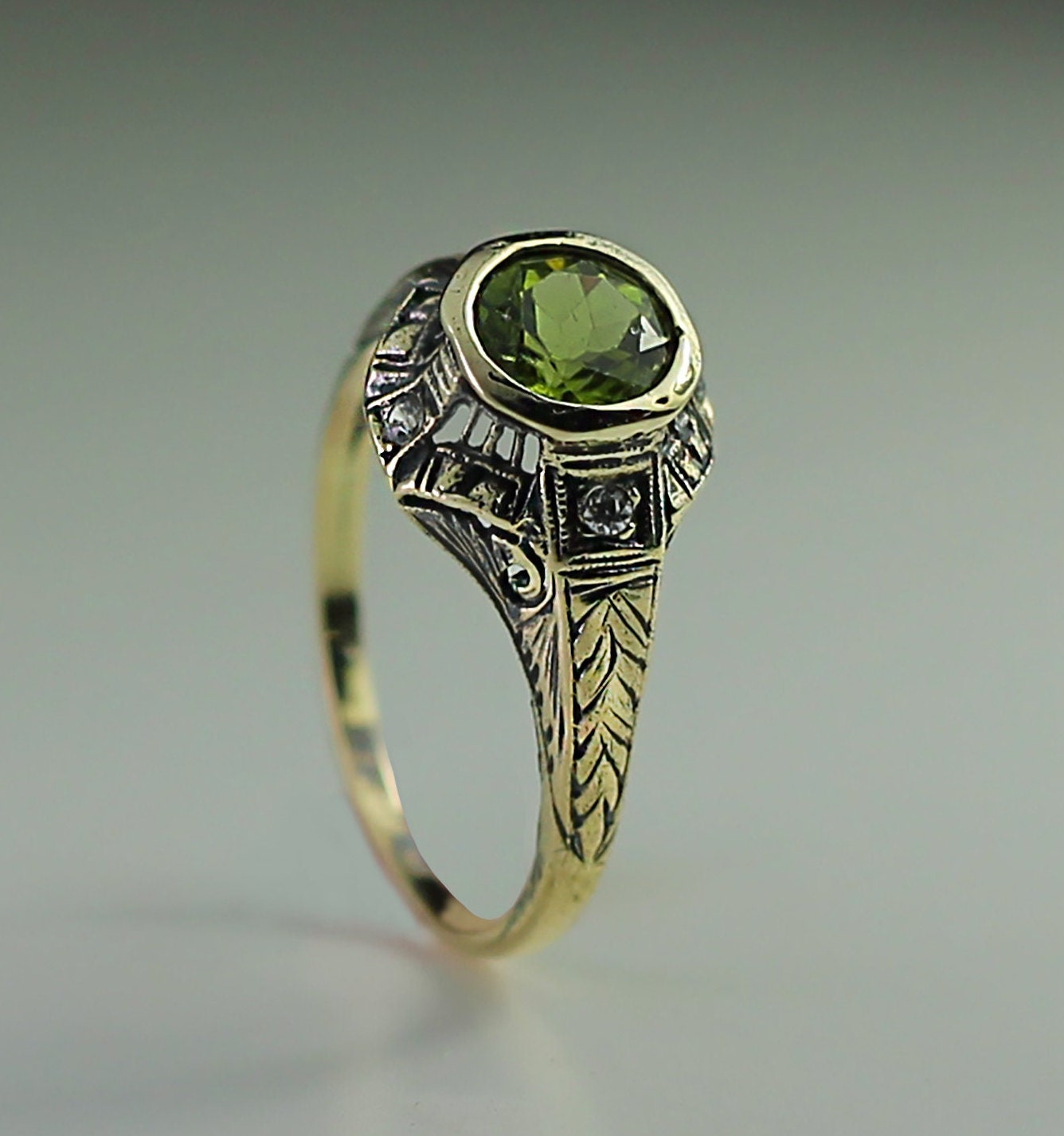 Very Unique Antique style Ring , Real 14K Gold, With a real Peridot gemstone and Diamonds.