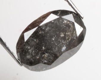 May include: A dark grey oval-shaped diamond with a faceted cut.