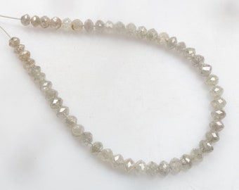 May include: A strand of grey diamond beads strung on a thin wire.