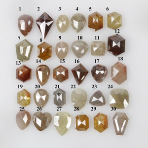 May include: Thirty loose, faceted, brown, gray, and yellow diamonds, numbered 1 through 30, arranged in rows on a white surface.