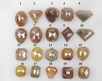 May include: Twenty loose, faceted, rough diamonds in various shapes and sizes, including round, oval, square, and heart shapes. The diamonds are a mix of brown, yellow, and gray colors.