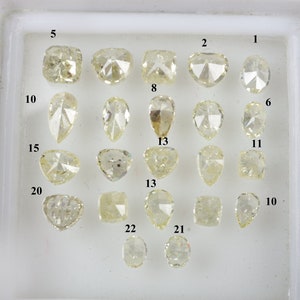 May include: A tray of 22 loose diamonds, each with a unique cut and shape, displayed on a white background. The diamonds are numbered 1 through 22.