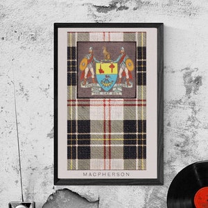 May include: A framed print of the MacPherson tartan with the MacPherson clan crest. The tartan is a mix of black, white, red, and yellow plaid. The crest features a silver stag with a red tongue and a blue and yellow shield.