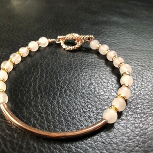 Round Moonstone and Rose Gold Bracelet with Rose Gold Tube and Rose Gold Toggle Clasp.