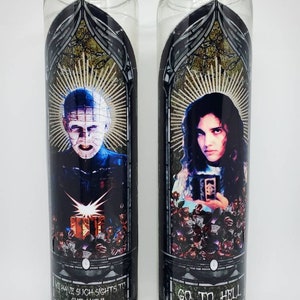 May include: Two glass candle holders with black and gold designs. The left candle holder features a character from the movie Hellraiser with the text "We have such sights to show you!" The right candle holder features a character from the movie The Exorcist with the text "Go to Hell."