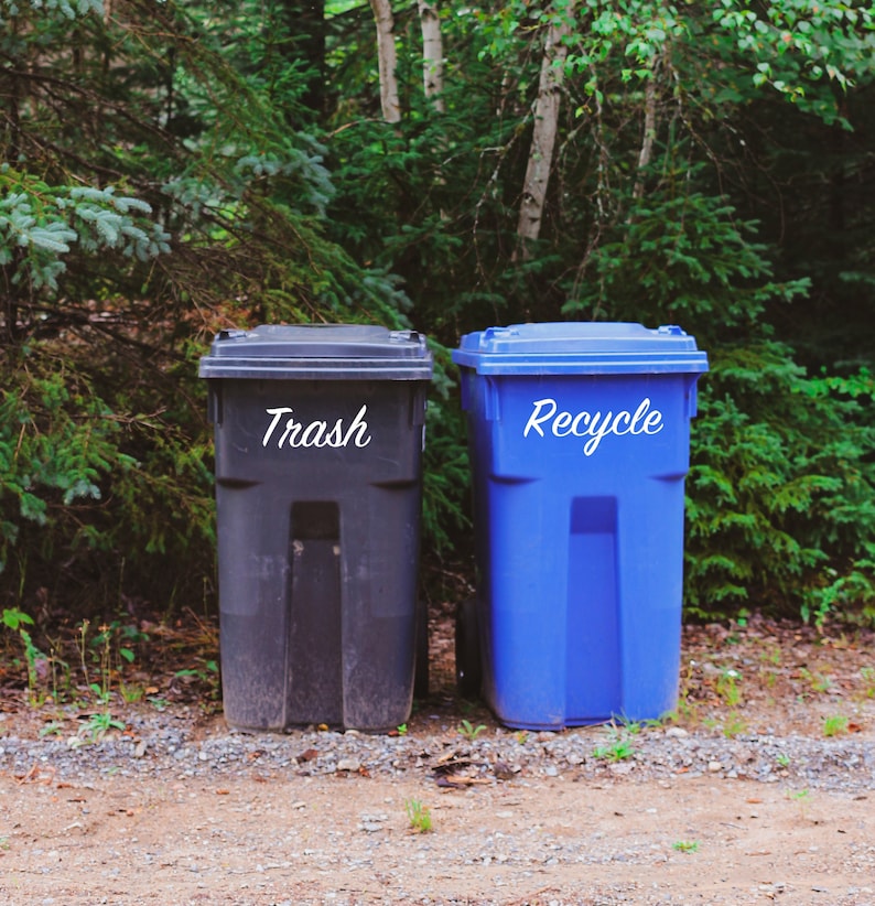 Picture of trash and recycling cans with decals labeling them.