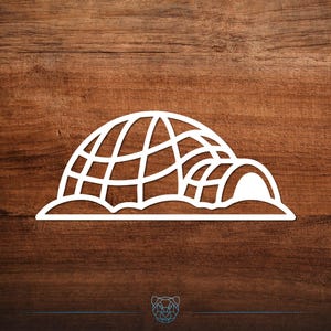 May include: White, stylized igloo design. The igloo is depicted with a domed roof and an entrance, set against a dark wood grain background. The design is a simple, clean illustration, suitable for various applications.