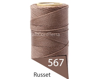 May include: A spool of russet-colored cord, labeled with the number 567. The cord is tightly wound around a cardboard core. The brand name "CraftCordTerra" is visible on the spool.