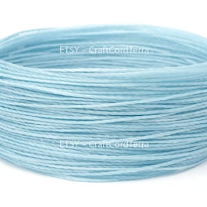 May include: A spool of light blue waxed cotton cord. The cord is wound tightly and is ready to be used for crafting projects. ETSY - CraftCordTerra