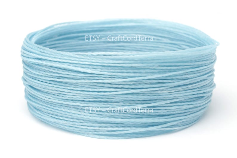 May include: A spool of light blue waxed cotton cord. The cord is wound tightly and is ready to be used for crafting projects. ETSY - CraftCordTerra