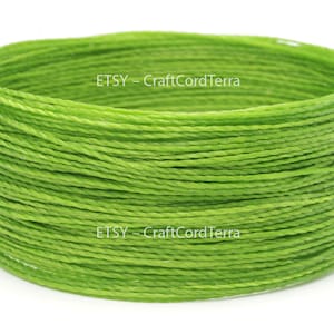 May include: A close-up of a spool of bright green waxed cotton cord. The cord is tightly wound and the spool is labeled "ETSY - CraftCordTerra".