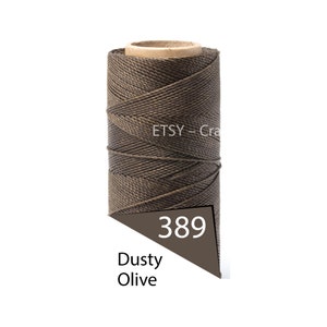 May include: A spool of dusty olive-coloured waxed cord. The cord is tightly wound around a cardboard core. A label displays the number 389 and the words "Dusty Olive". The Etsy logo is visible.