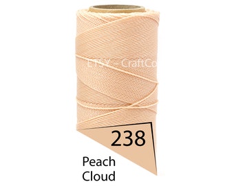 May include: A spool of peach-colored thread labeled "238 Peach Cloud." The thread is tightly wound around a cardboard core. The Etsy CraftCo logo is visible on the spool.