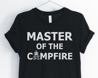 May include: Black t-shirt with white text that reads "Master of the Campfire" with a campfire graphic.