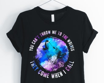 May include: Black t-shirt with a wolf howling at the moon graphic. The graphic is surrounded by a circle with the text "You can't throw me to the wolves they come when I call".