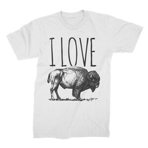 May include: White t-shirt with the text "I LOVE" printed in black above a black and white illustration of a bison.