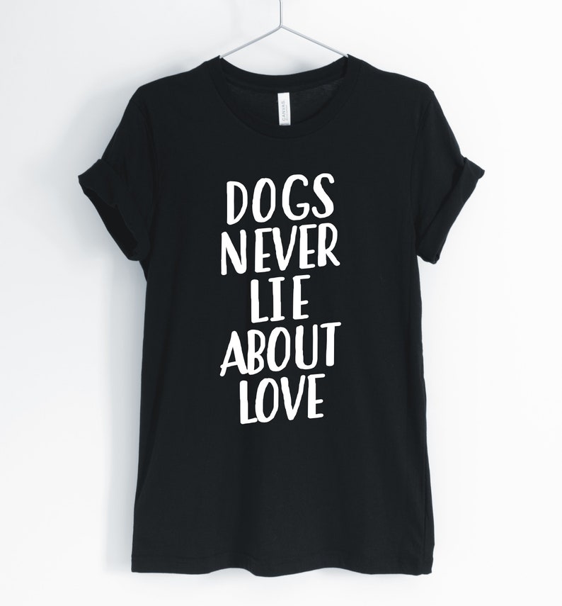 May include: Black t-shirt with white text that reads "Dogs Never Lie About Love".