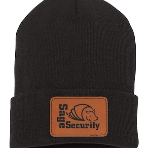 May include: Black knitted beanie with a brown leather patch that says "Sage Security" and features a stylised armadillo logo.