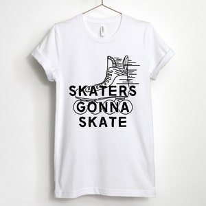 May include: White t-shirt with a black graphic of a roller skate and the words "SKATERS GONNA SKATE". The design features a line drawing of a roller skate with speed lines, and the text is in a bold, sans-serif font.
