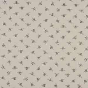May include: Beige fabric featuring a repeating pattern of dark grey bees. The bees are shown with their wings spread, creating a scattered design. The fabric has a slightly textured appearance.