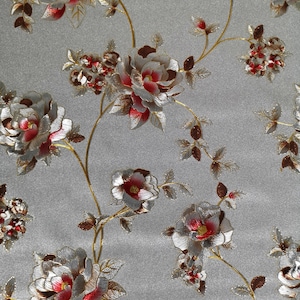 May include: Silver and red floral wallpaper with a repeating pattern of roses and vines. The wallpaper has a subtle shimmer.