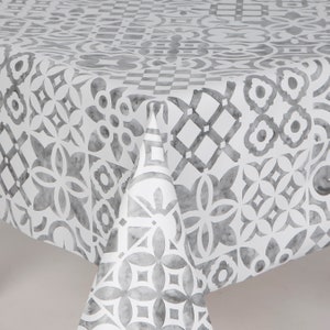 May include: White tablecloth with a gray geometric pattern. The pattern is reminiscent of tiles.