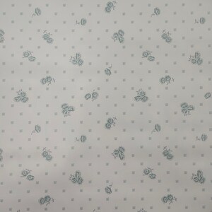 May include: A white background with a repeating pattern of small, light green floral designs.
