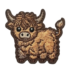 May include: Embroidered patch featuring a Highland cow. The patch has a brown and tan color scheme, with detailed stitching that brings the cow to life. The cow has large, expressive eyes and a fluffy coat.