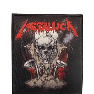 May include: Black rectangular patch featuring the word "METALLICA" in red, stylized lettering above a skull graphic. The skull has a skeletal torso and is set against a backdrop of lightning and red hues.