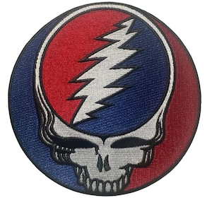 May include: Embroidered patch featuring the Steal Your Face logo. The design includes a white lightning bolt over a skull, set against a red and blue background. The patch is circular and has a detailed, stitched appearance.