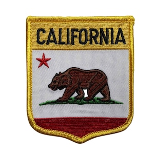 May include: Embroidered patch featuring the California state flag design. The patch has a gold border and a white background with a brown bear, a red star, and the word "CALIFORNIA" in black.