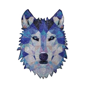May include: A detailed, embroidered patch featuring a wolf's head. The design showcases a mosaic-like pattern in shades of blue, purple, and white, with piercing blue eyes. The patch has a jagged edge, giving it a textured appearance.