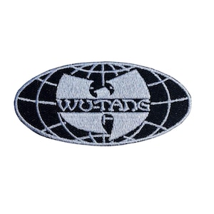 May include: An embroidered patch featuring the Wu-Tang Clan logo. The design is an oval shape with a black background and a white outline. The Wu-Tang Clan logo is in white, with the text "WU-TANG" and a "W" symbol.