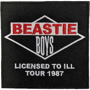 May include: A square black embroidered patch featuring a white diamond outline. The text BEASTIE in red and BOYS in white are centered within the diamond. Below the diamond, the text LICENSED TO ILL TOUR 1987 is embroidered in white thread.