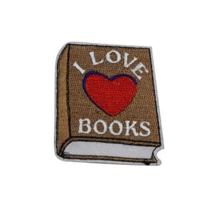 May include: Embroidered patch in the shape of a book with the words "I LOVE BOOKS" and a red heart. The book is brown with a white border and the text is in white.