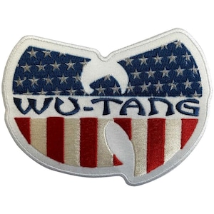 May include: Embroidered patch featuring the Wu-Tang Clan logo in a shield shape. The top portion has a blue background with white stars, and the bottom has red and white stripes. The text "WU-TANG" is embroidered in blue.