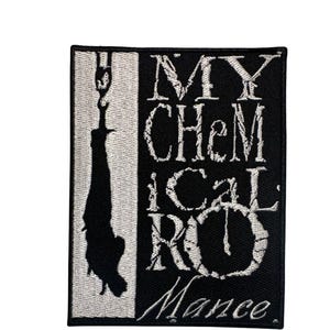 May include: A rectangular embroidered patch featuring a black and white design. The left side shows a silhouette of a figure hanging from a crane hook. The right side displays the text MY CHEMICAL ROMANCE in a distressed, stylized white font.