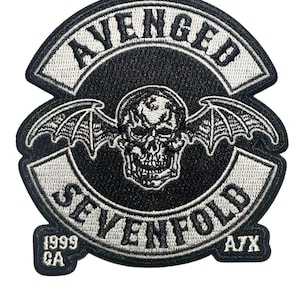 May include: Black and white embroidered patch featuring the words "AVENGED SEVENFOLD" and a skull with bat wings. The patch includes the text "1999 CA" and "A7X".