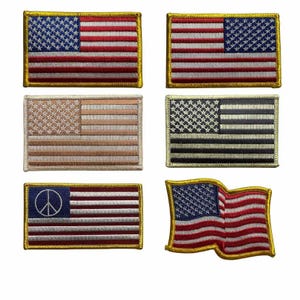 May include: A collection of embroidered patches featuring the American flag. The patches showcase the flag in various styles, including traditional red, white, and blue, as well as alternative color schemes and designs, such as a peace sign.