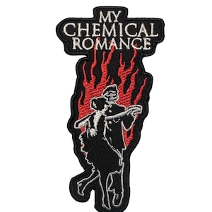 May include: Embroidered patch featuring the text "MY CHEMICAL ROMANCE" in white on a black background. Below the text is a black silhouette of two figures dancing in front of red flames. The patch has a black border.