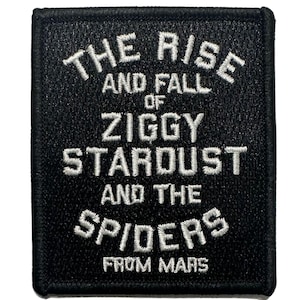 May include: Square black patch with white embroidered text. The text reads "THE RISE AND FALL OF ZIGGY STARDUST AND THE SPIDERS FROM MARS". The patch has a black border and a textured surface.