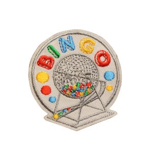 May include: Embroidered patch featuring a bingo game design. The word "BINGO" is spelled out in colorful letters around a gray bingo ball cage filled with colorful balls. The patch has a gray border.