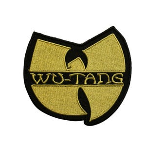 May include: Embroidered patch featuring the Wu-Tang Clan logo. The patch has a gold-colored emblem with the words "WU-TANG" in black lettering, set against a black background. The patch is in the shape of the Wu-Tang Clan logo.