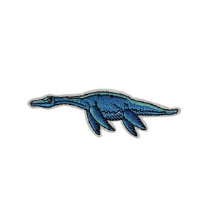 May include: Embroidered patch featuring a blue plesiosaur, a prehistoric marine reptile. The patch has a detailed design with varying shades of blue and a gray border. The plesiosaur is depicted with a long neck and flippers.
