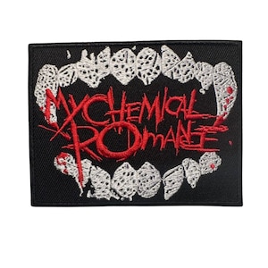 May include: Black embroidered patch featuring the text "MY CHEMICAL ROMANCE" in red, with a stylized white teeth design. The patch has a rectangular shape and is likely for clothing or accessories.
