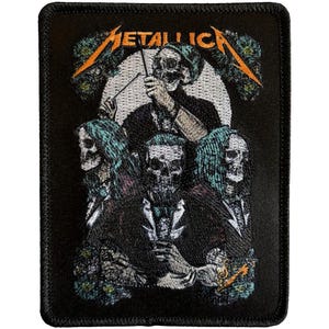 May include: Black rectangular patch featuring the band name "METALLICA" in orange and green. The patch depicts a group of skeletal figures in dark attire, with one figure holding a baton. The background is a white circle.