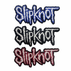 May include: Three embroidered patches featuring the word Slipknot in a stylized, jagged font. The top patch has blue lettering with a black border, the middle patch has white lettering with a black border, and the bottom patch has red lettering.