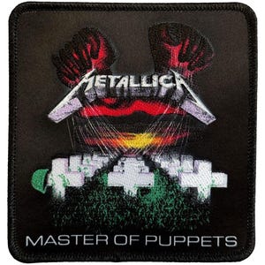 May include: Black square patch featuring the band name "METALLICA" in silver lettering above a graphic of red hands and a sunset. Below, white crosses and the text "MASTER OF PUPPETS" in white.